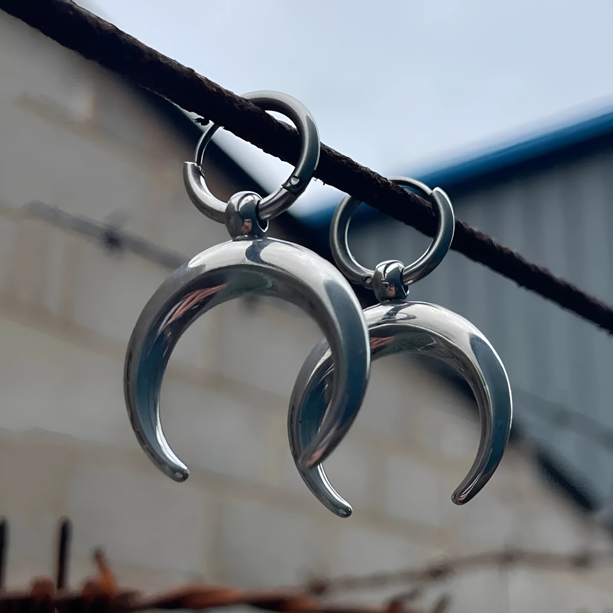 Silver geometric big hoop earrings with a gothic moon charm and clip-on fastening