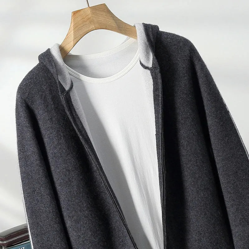 Man wearing a dark blue zip-up cardigan sweater with a half-high collar.