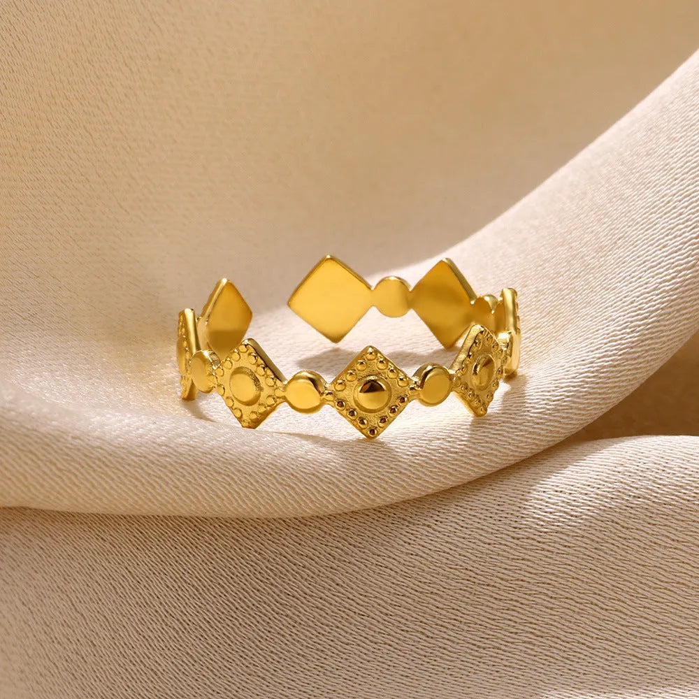 Golden geometric women's ring with diamond pattern on titanium steel band