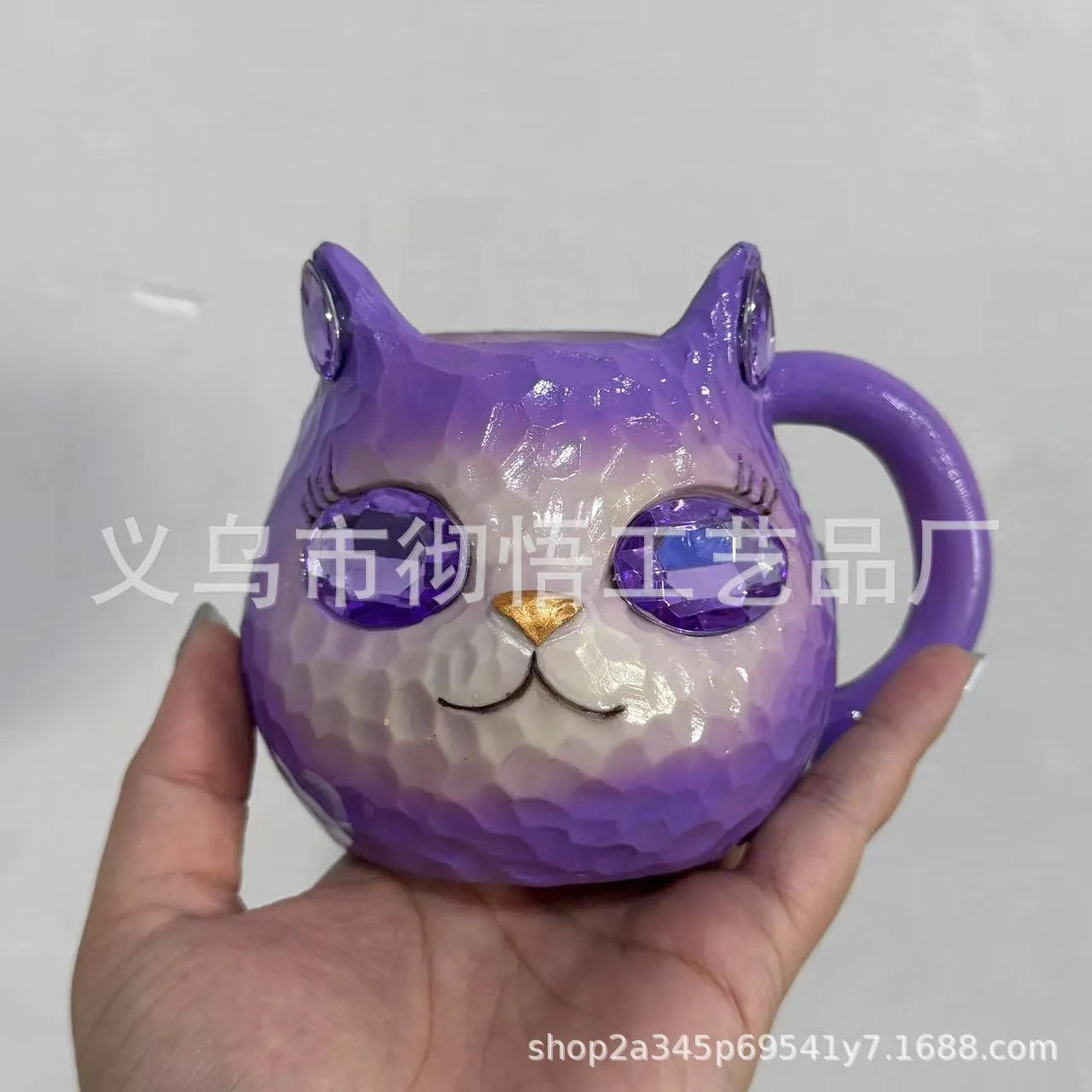 Coloured resin cat cup decoration in purple, green, blue, or pink on a shelf.
