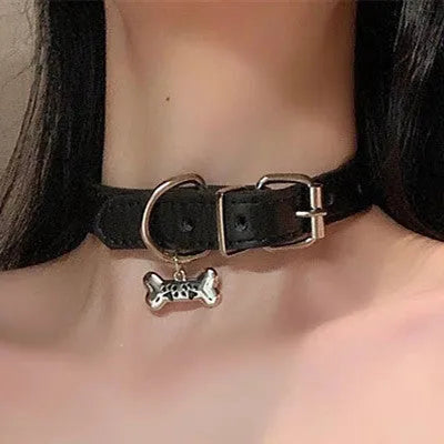 Black leather dog collar with brass bell charm in three designs: LD leather, bone pattern, and cat paw