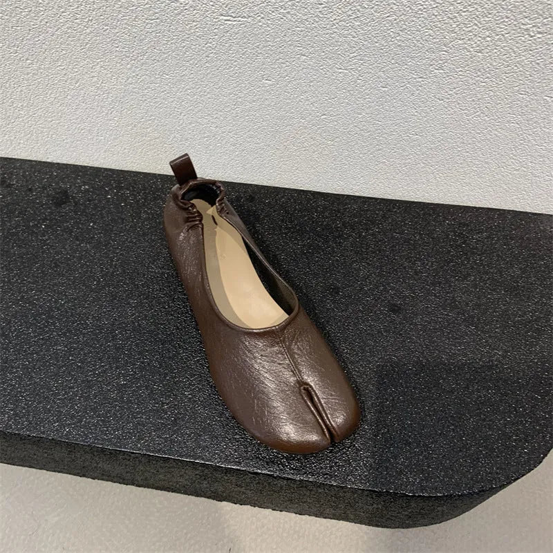 Women's apricot low chunky heel pumps with split toe and horseshoe peas detail on round toe.