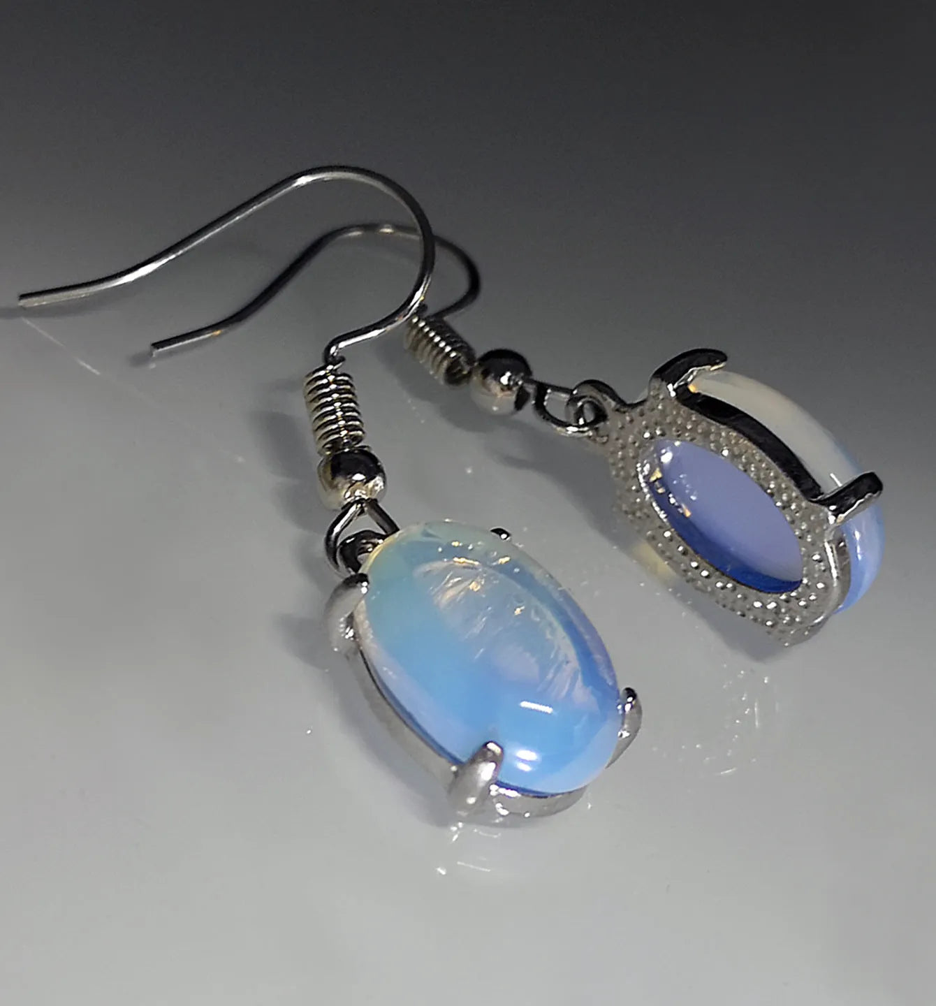 Opal earrings with retro moonstone cross design and ellipse elements in drop shape