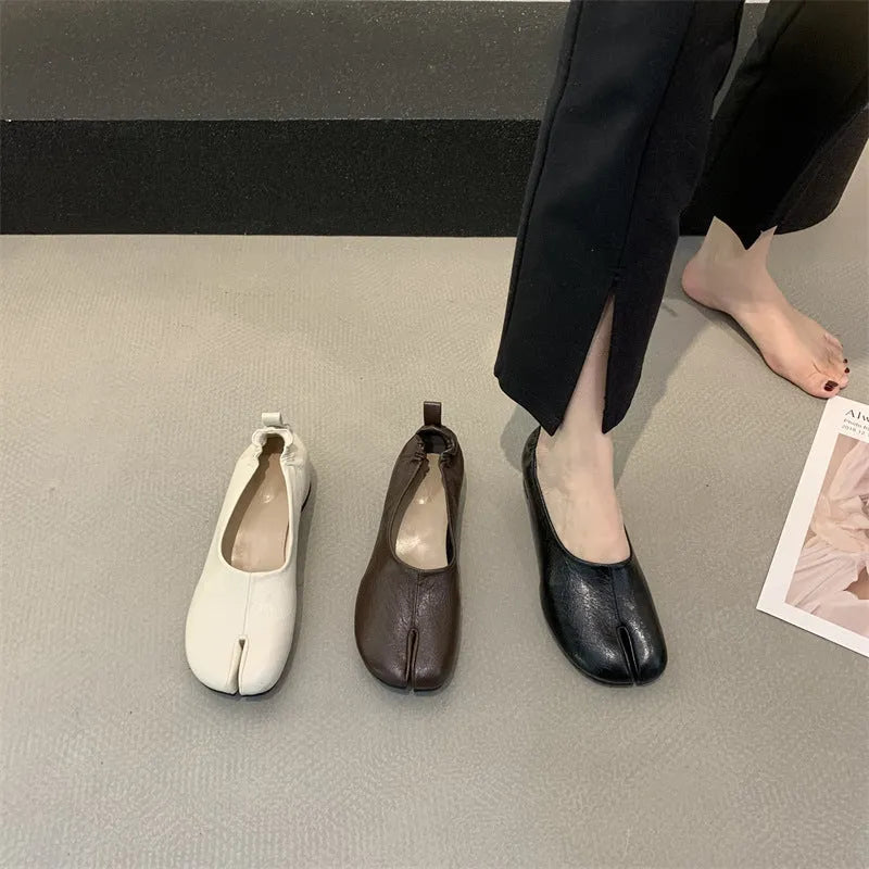 Women's apricot low chunky heel pumps with split toe and horseshoe peas detail on round toe.