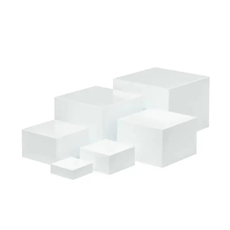 White plastic cube dessert display stand with six modular pieces arranged on tabletop