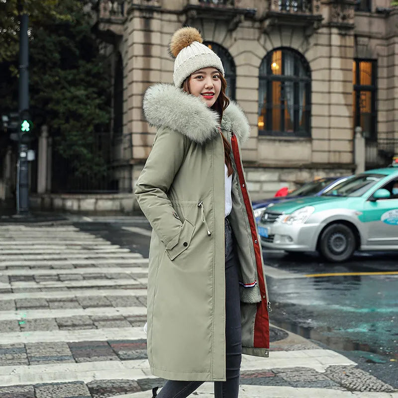 Women's long beige trench coat with fleece lining on a hanger, showing its extended length and elegant style.