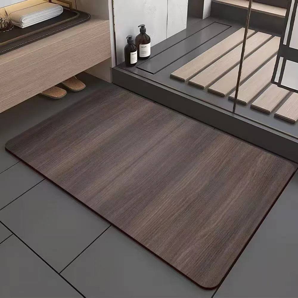 Square diatomite bathroom floor mat with geometric print in a wood grain colour on a tiled floor.