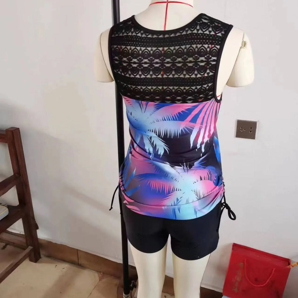 Women's floral printed two-piece swimsuit with sleeveless top and matching shorts in blue or green