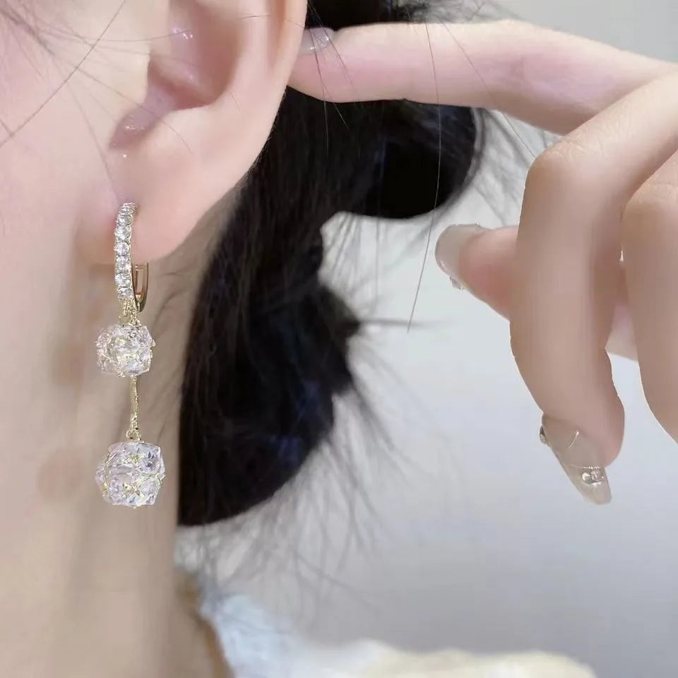 Women's silver drop earrings with confession balloon and rhinestone ball pendants connected by tassel detailing
