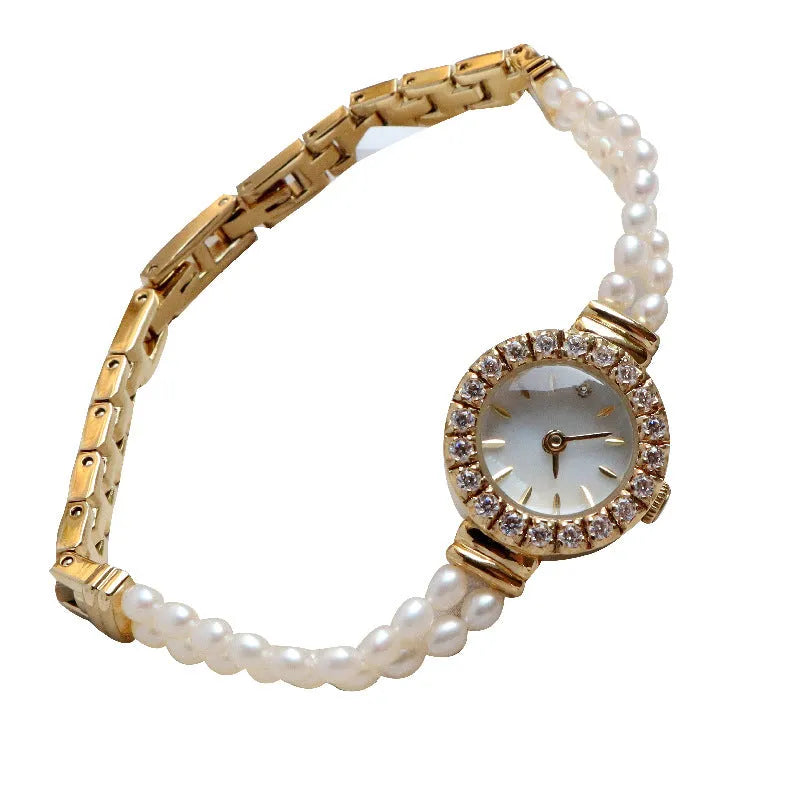 Women's light gold bracelet watch with freshwater pearl accents and round 18mm dial