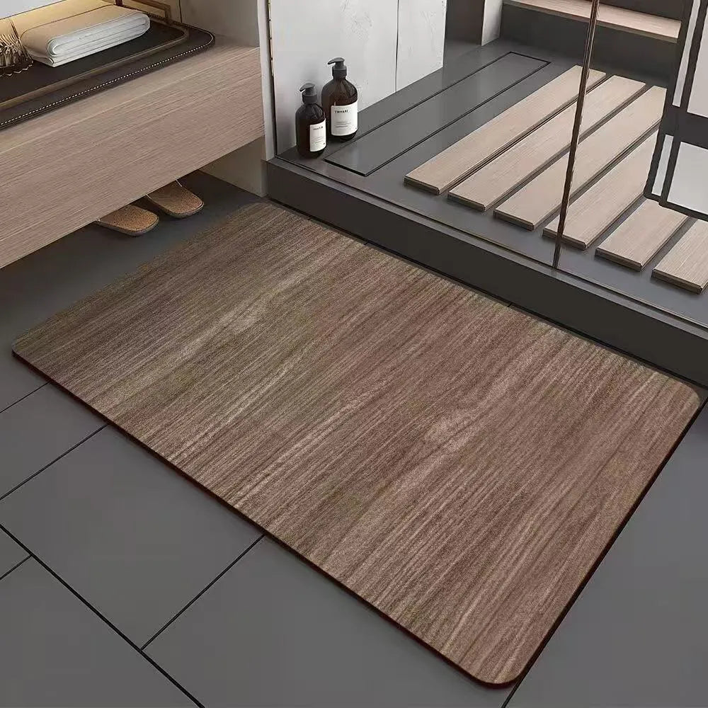 Square diatomite bathroom floor mat with geometric print in a wood grain colour on a tiled floor.