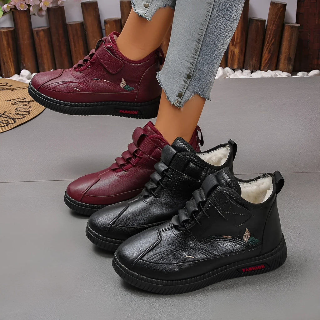 Women's black velvet low-cut indoor slippers with a non-slip rubber sole and decorative hollow out details.