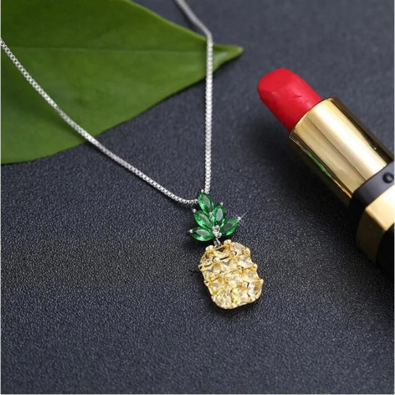 Silver geometric pineapple diamond pendant necklace on an adjustable chain.