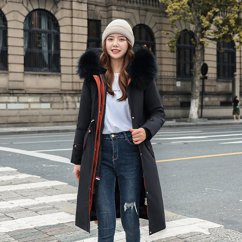Women's long beige trench coat with fleece lining on a hanger, showing its extended length and elegant style.