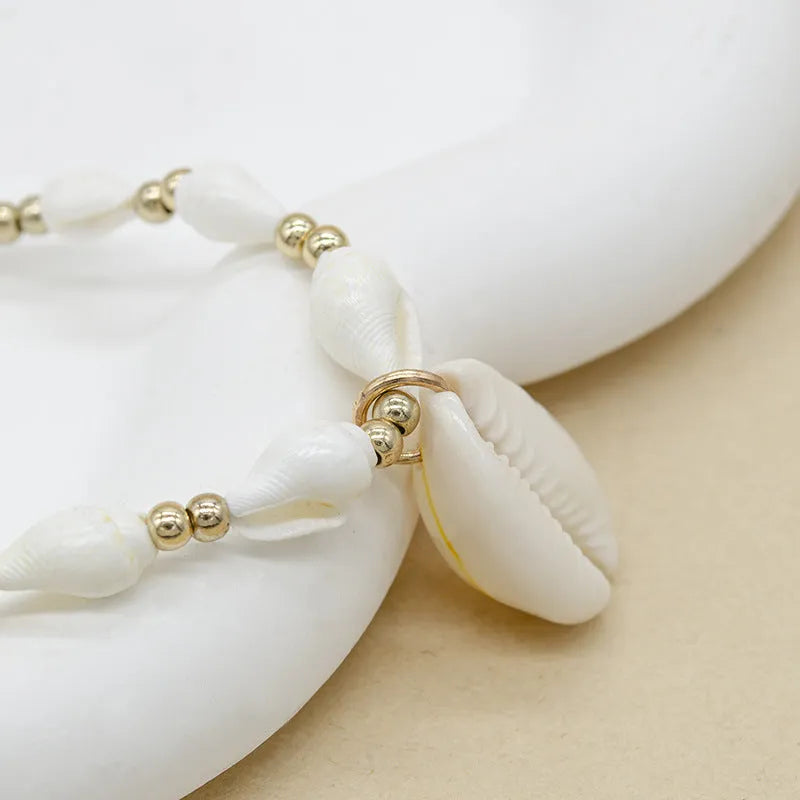 White conch shell bead necklace with a real mother-of-pearl pendant on a regular chain.