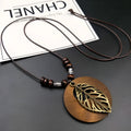 Wooden leaf pendant necklace on adjustable wax line chain showing ethnic design
