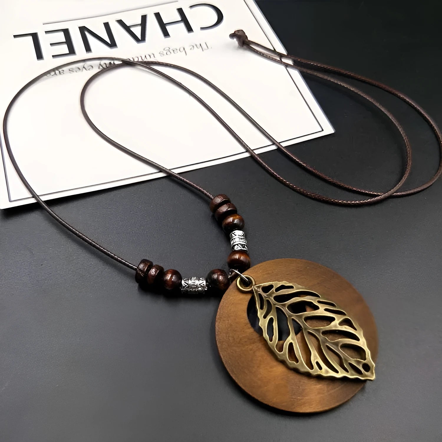 Wooden leaf pendant necklace on adjustable wax line chain showing ethnic design