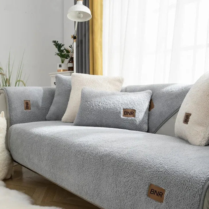 Lambswool sofa cover in solid blue colour on a three-seater sofa