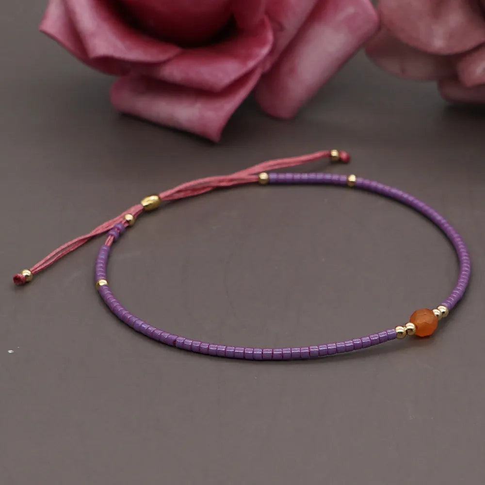 Women's handmade bohemian bracelet with semi-precious stone bead and colourful glass beads.