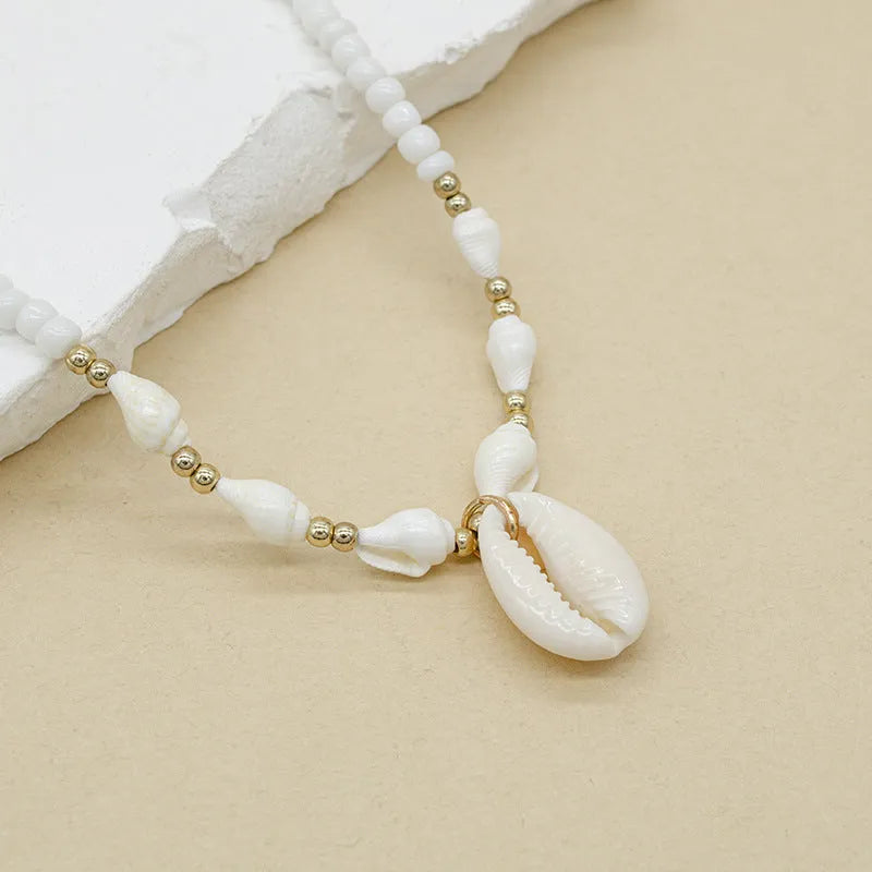 White conch shell bead necklace with a real mother-of-pearl pendant on a regular chain.