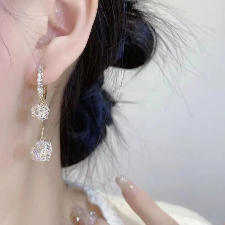 Women's silver drop earrings with confession balloon and rhinestone ball pendants connected by tassel detailing