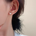 A pair of women's simple fishtail design earrings in an electroplated gold colour.