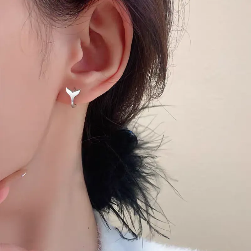 A pair of women's simple fishtail design earrings in an electroplated gold colour.