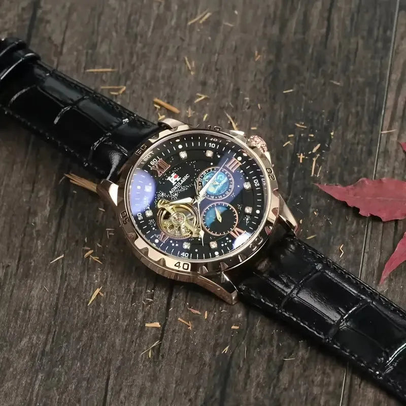 Men's black and rose gold automatic watch with hollow dial and leather strap.