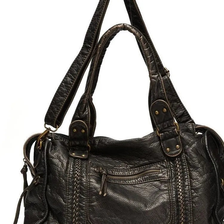 Women's retro motorcycle messenger shoulder bag with woven detail showing organised interior compartments