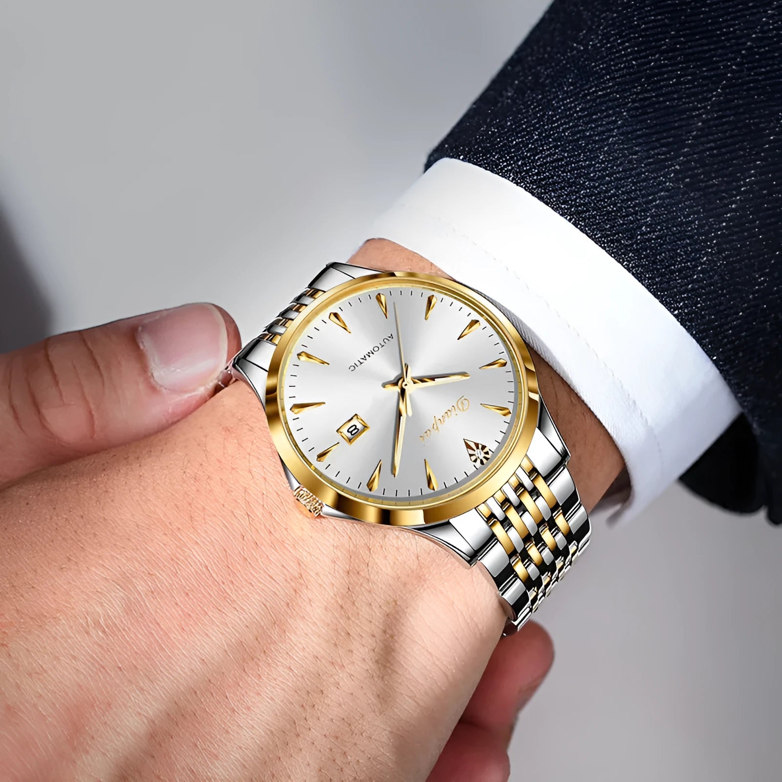 Men's stainless steel automatic mechanical watch with simple dial on wrist.