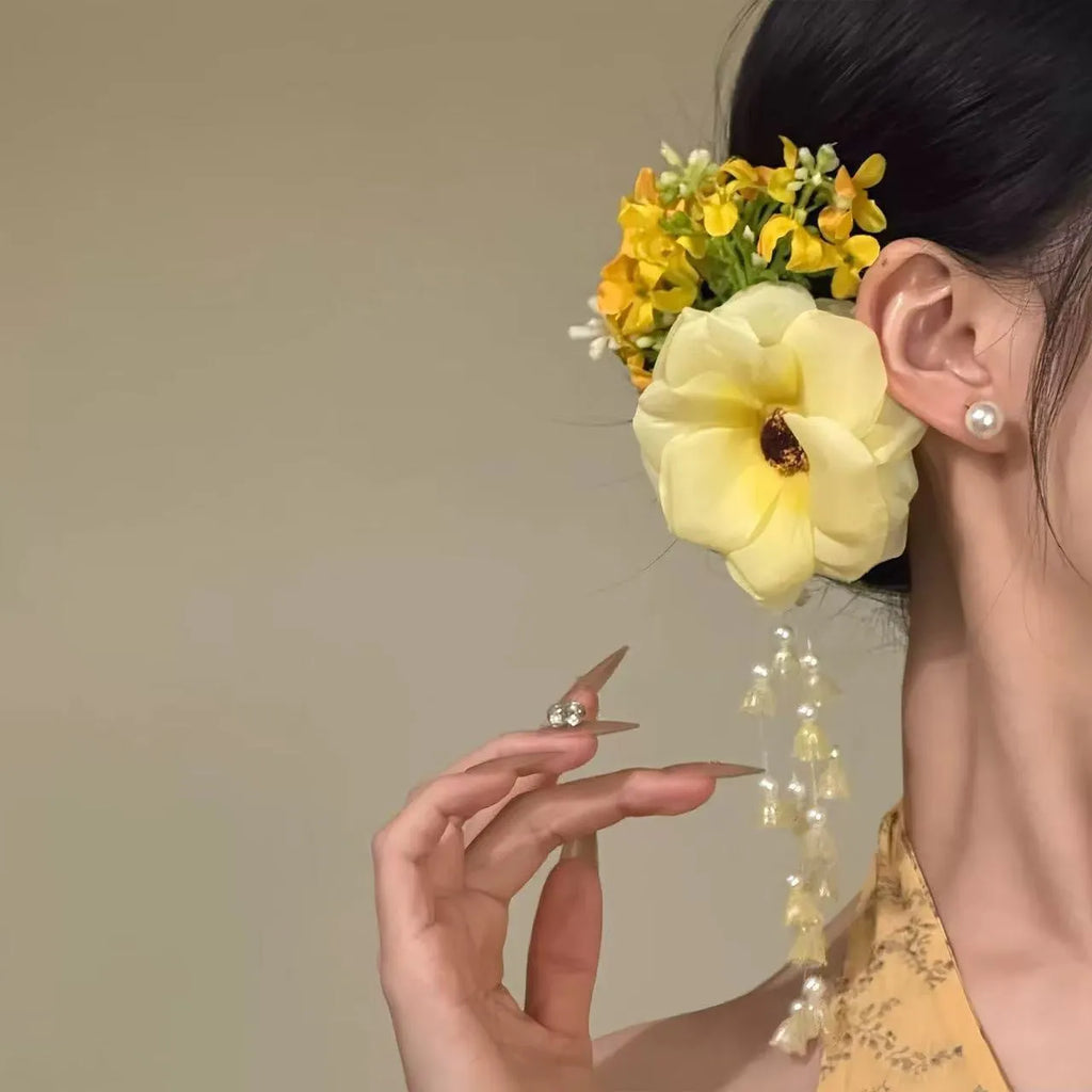 Yellow flower tassel hair clip with pearl and linglan elements on white background