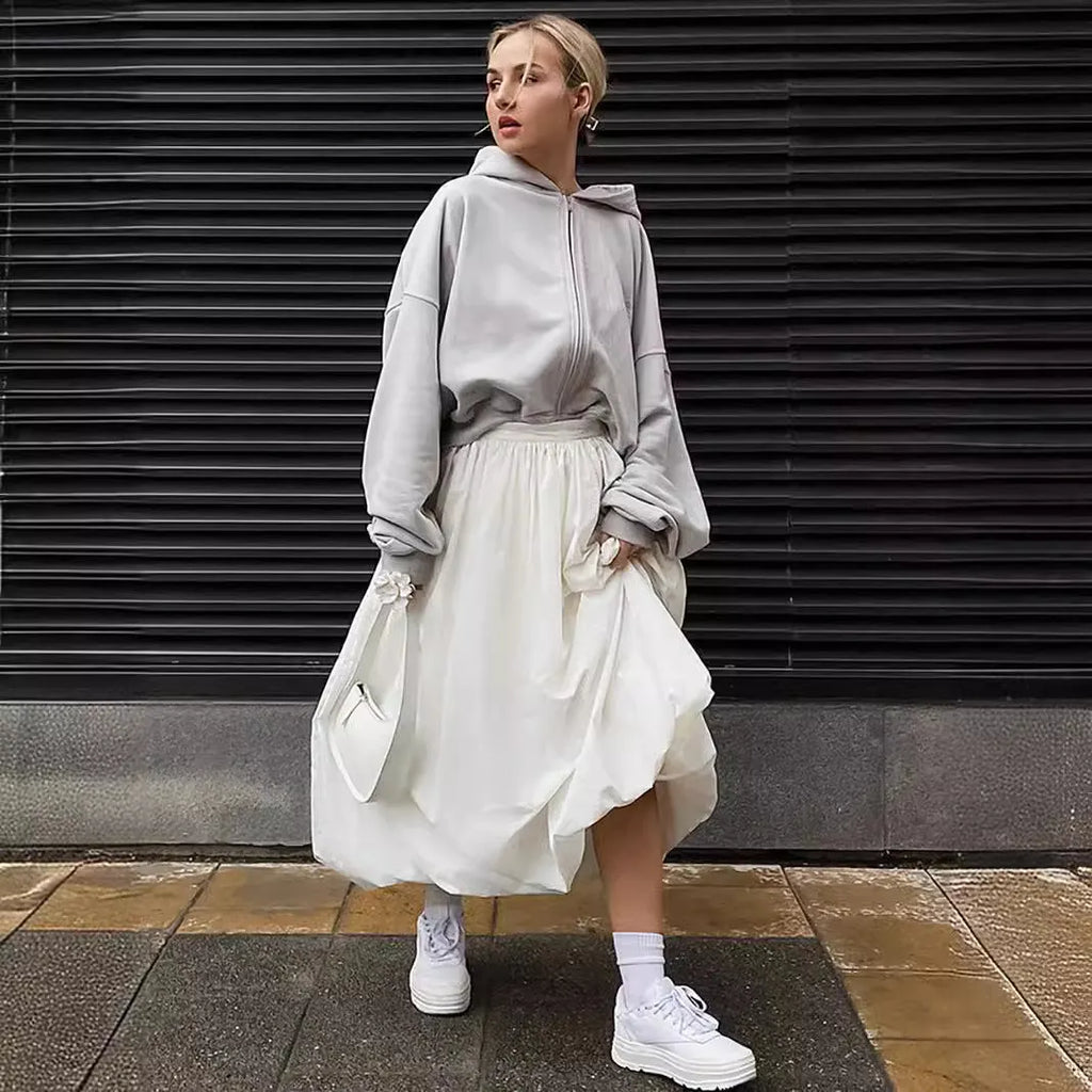 Women's long solid colour cotton skirt on a hanger, showing elasticated waist.