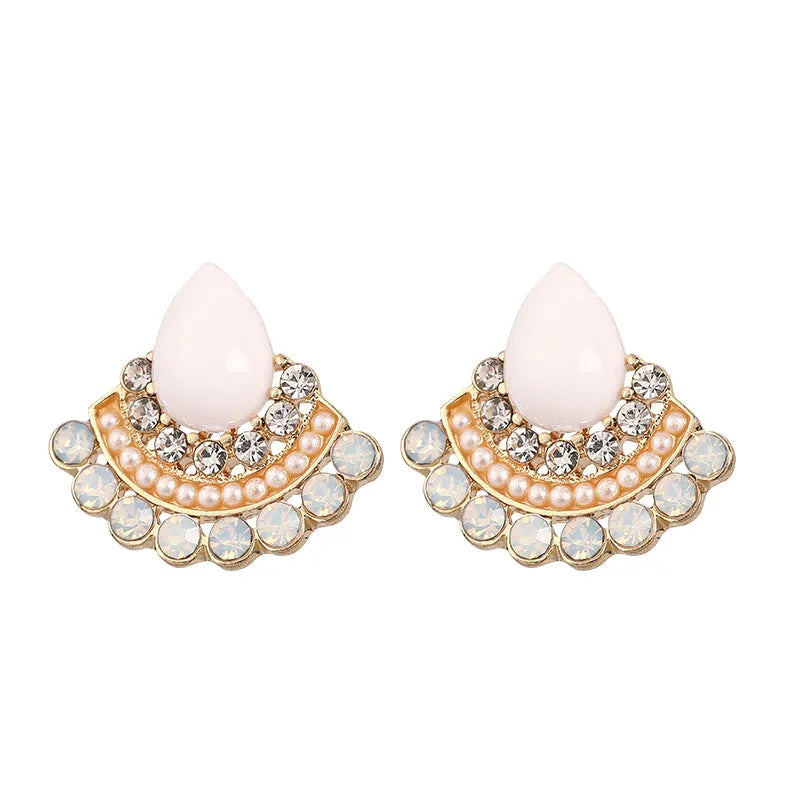 Silver fan-shaped drop earrings with rhinestone and opal geometric design on white background