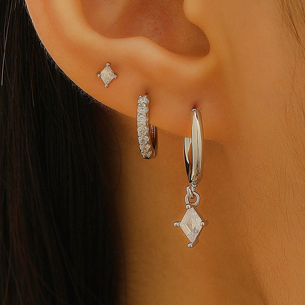 Ladies three-piece earring set with geometric designs and zircon accents in gold or white finish
