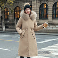 Women's long beige trench coat with fleece lining on a hanger, showing its extended length and elegant style.