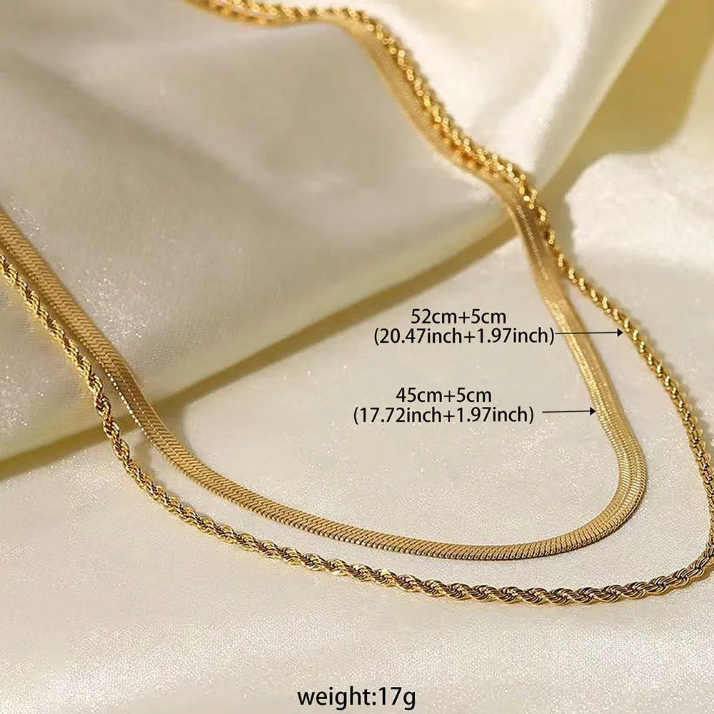 Close-up of a geometric double-layer twist pendant necklace on a textured snake bones chain.
