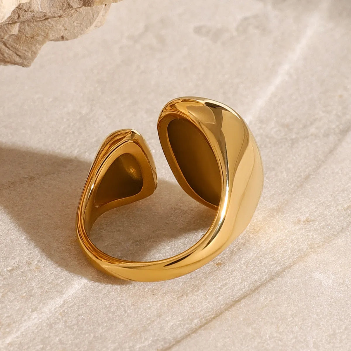 Women's exaggerated geometric stainless steel open ring with electroplated finish.