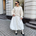 Women's long solid colour cotton skirt on a hanger, showing elasticated waist.
