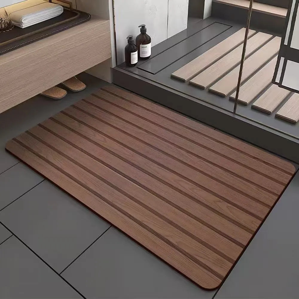 Square diatomite bathroom floor mat with geometric print in a wood grain colour on a tiled floor.