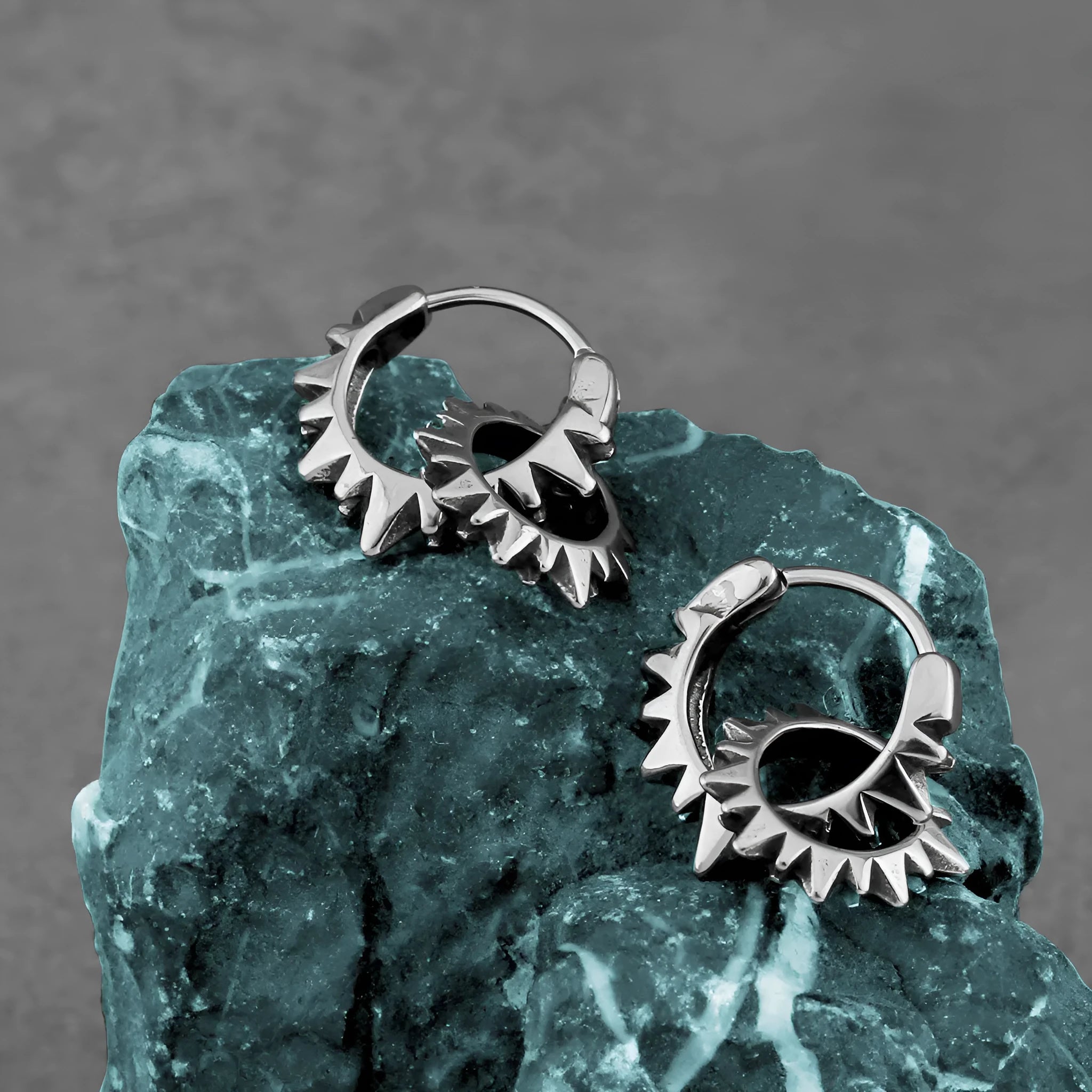 Pair of simple stainless steel round ring earrings with a polished finish and steel colour.