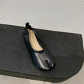 Women's apricot low chunky heel pumps with split toe and horseshoe peas detail on round toe.