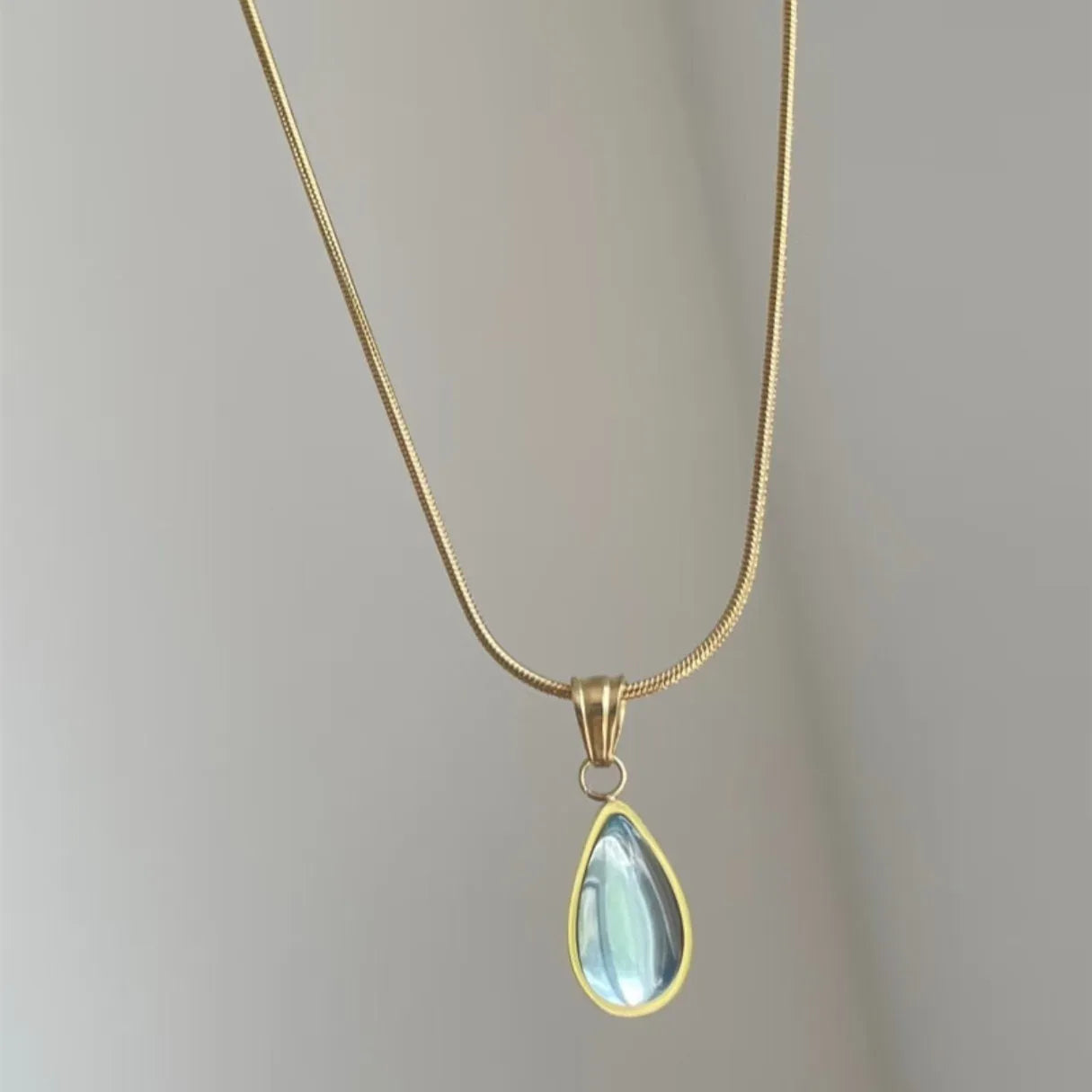 Water drop necklace with mixed gem pendant on titanium snake chain in blue or green.