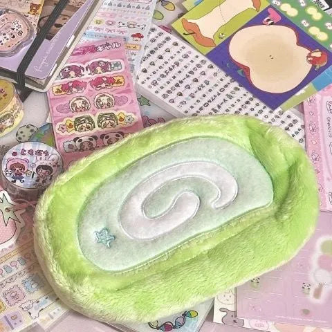 Honeydew Swiss roll cake design velvet pencil case on a flat surface