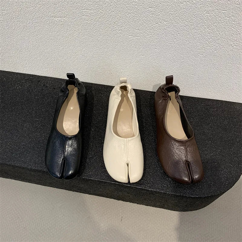 Women's apricot low chunky heel pumps with split toe and horseshoe peas detail on round toe.