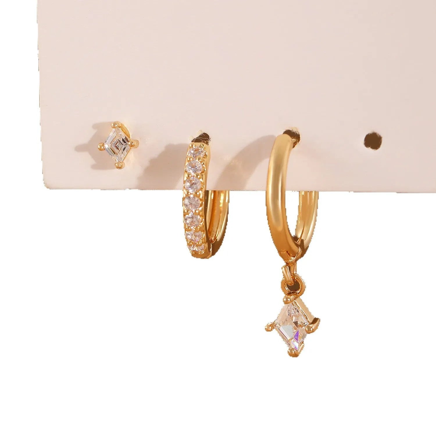 Ladies three-piece earring set with geometric designs and zircon accents in gold or white finish