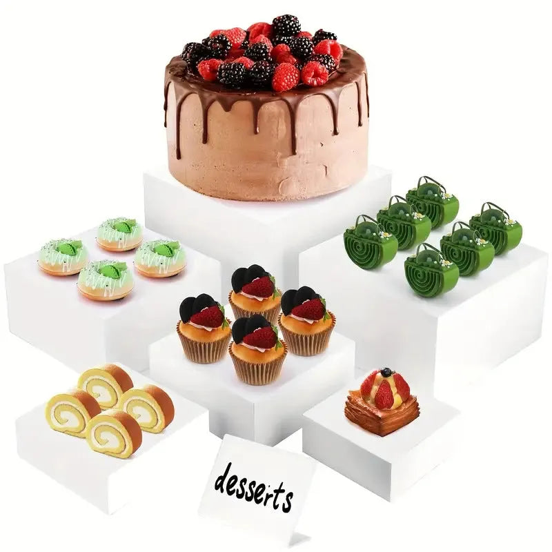 White plastic cube dessert display stand with six modular pieces arranged on tabletop
