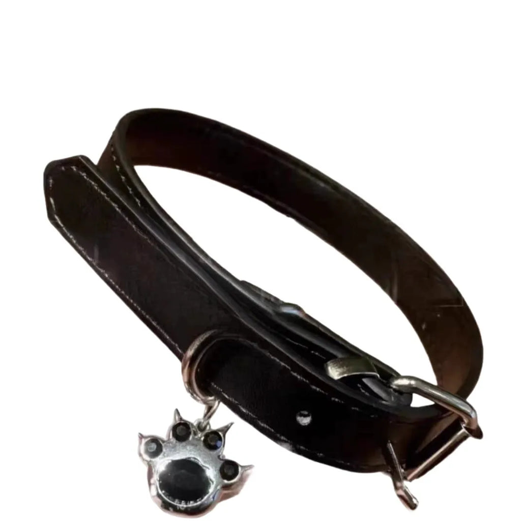 Black leather dog collar with brass bell charm in three designs: LD leather, bone pattern, and cat paw