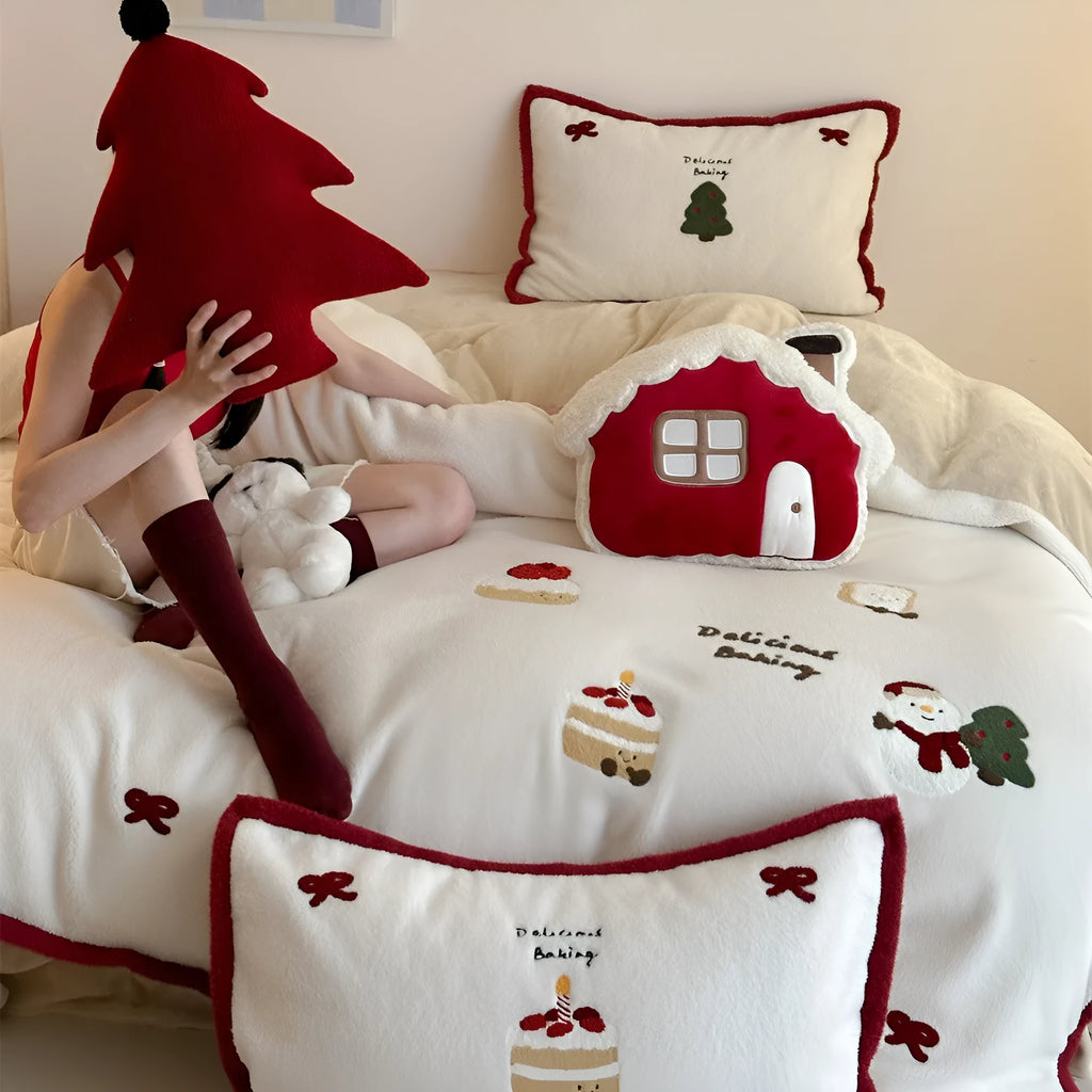 Winter Christmas cartoon print bed linen four-piece set showing fitted sheet, duvet cover, and pillowcases.