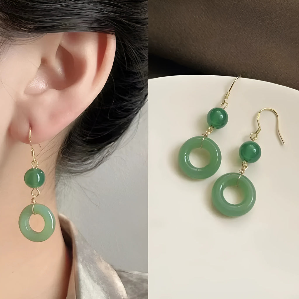 A pair of green geometric Peace Buckle-shaped earrings inspired by traditional Chinese cheongsam design.