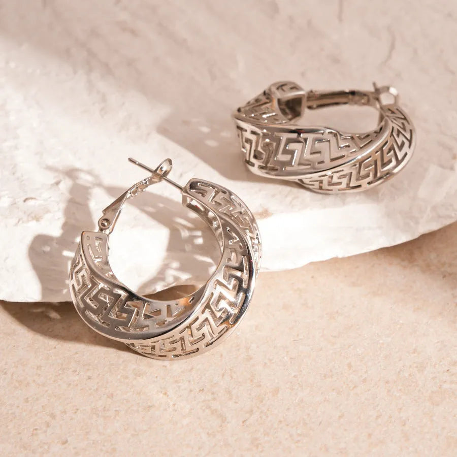 Geometric hollow stud earrings with twisted round design in gold or silver finish